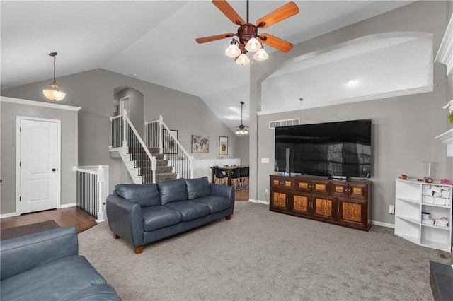 957 NW Dogwood Dr, Grain Valley, MO 64029 - living room featuring ceiling fan, arched walkways, vaulted ceiling, stairs, and baseboards