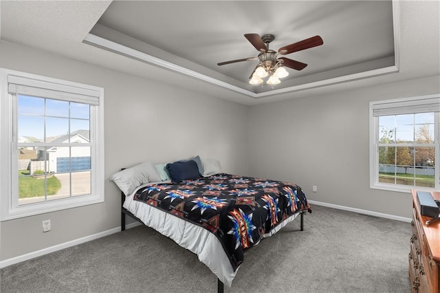 957 NW Dogwood Dr, Grain Valley, MO 64029 - bedroom with a raised ceiling, carpet flooring, baseboards, and a ceiling fan