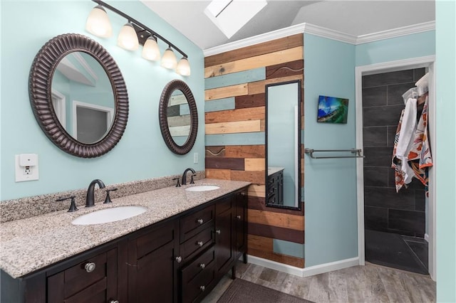 957 NW Dogwood Dr, Grain Valley, MO 64029 - bathroom featuring wood finished floors, ornamental molding, wooden walls, and double vanity
