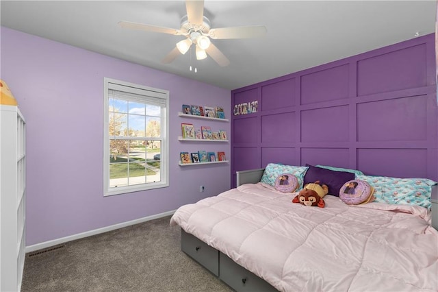 957 NW Dogwood Dr, Grain Valley, MO 64029 - carpeted bedroom with baseboards, ceiling fan, and a decorative wall