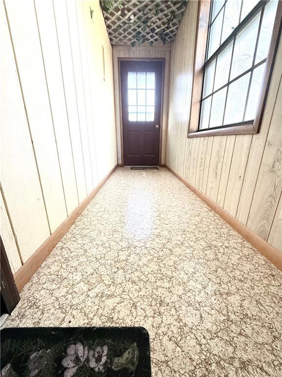 doorway featuring wood walls