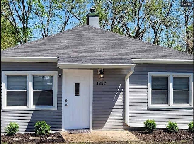 1837 S 16th St, Kansas City, KS 66103 - doorway to property with a shingled roof and a chimney