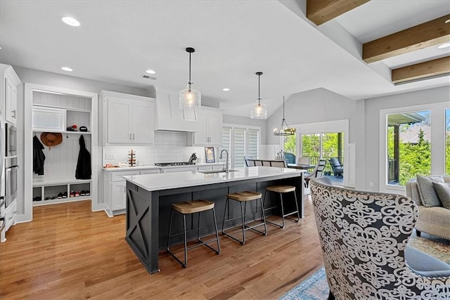 22622 W 87th Ter, Lenexa, KS 66227 - kitchen featuring a sink, white cabinetry, light countertops, and recessed lighting