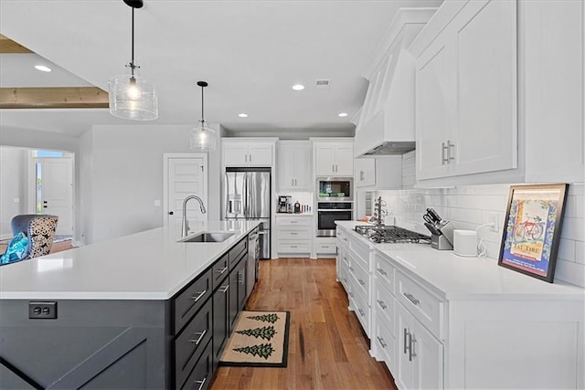 22622 W 87th Ter, Lenexa, KS 66227 - kitchen with stainless steel appliances, a sink, white cabinetry, light countertops, and recessed lighting