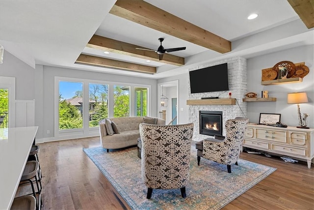 22622 W 87th Ter, Lenexa, KS 66227 - living area with a stone fireplace, wood finished floors, beam ceiling, ceiling fan, and recessed lighting