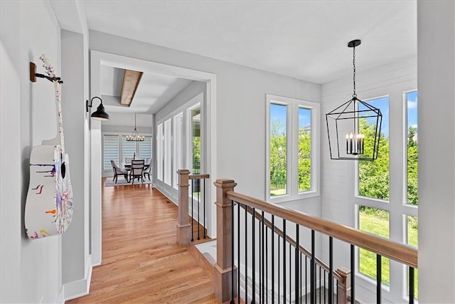 22622 W 87th Ter, Lenexa, KS 66227 - hall featuring a chandelier, an upstairs landing, and light wood-type flooring