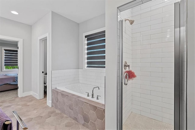 22622 W 87th Ter, Lenexa, KS 66227 - bathroom with a stall shower, a bath, tile patterned flooring, baseboards, and toilet