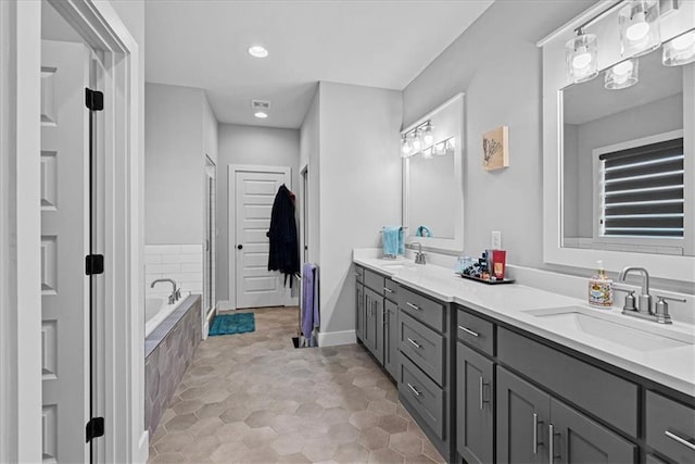 22622 W 87th Ter, Lenexa, KS 66227 - full bath featuring double vanity, baseboards, a relaxing tiled tub, and recessed lighting