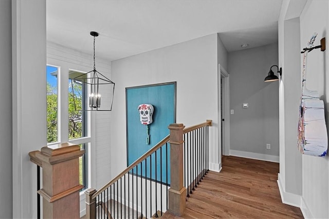22622 W 87th Ter, Lenexa, KS 66227 - corridor featuring an upstairs landing, a chandelier, wood finished floors, and baseboards
