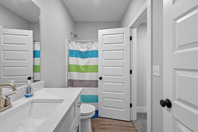 22622 W 87th Ter, Lenexa, KS 66227 - full bathroom with wood finished floors, vanity, toilet, and a shower with curtain