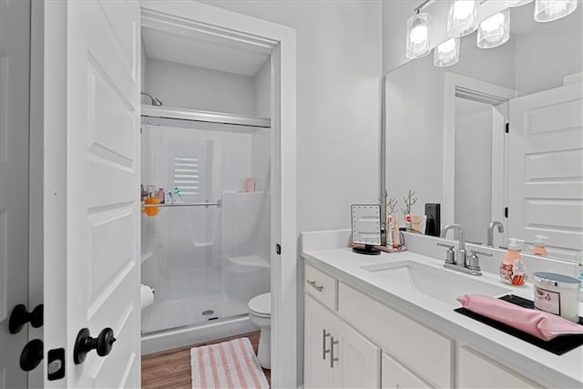 22622 W 87th Ter, Lenexa, KS 66227 - bathroom with toilet, a stall shower, vanity, and wood finished floors