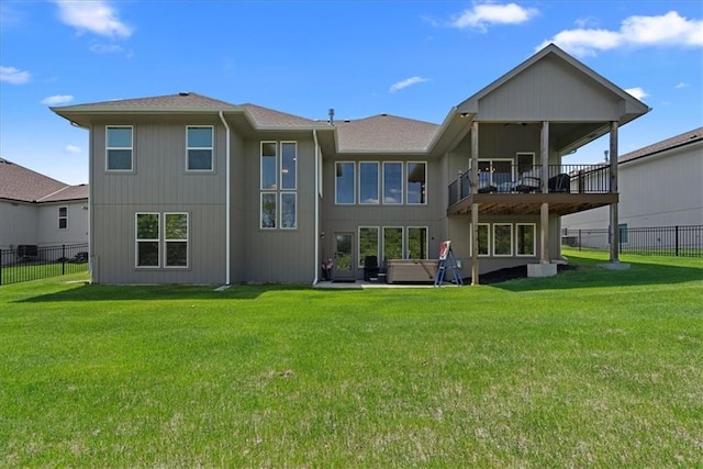 22622 W 87th Ter, Lenexa, KS 66227 - back of property with roof with shingles and a hot tub