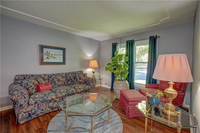 living area featuring wood finished floors and baseboards