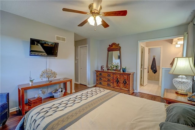 bedroom featuring baseboards, a ceiling fan, visible vents, and wood finished floors