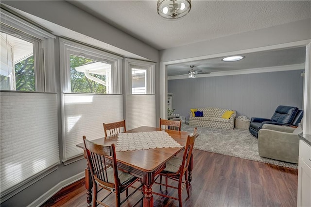 dining space featuring ornamental molding, a ceiling fan, and wood finished floors