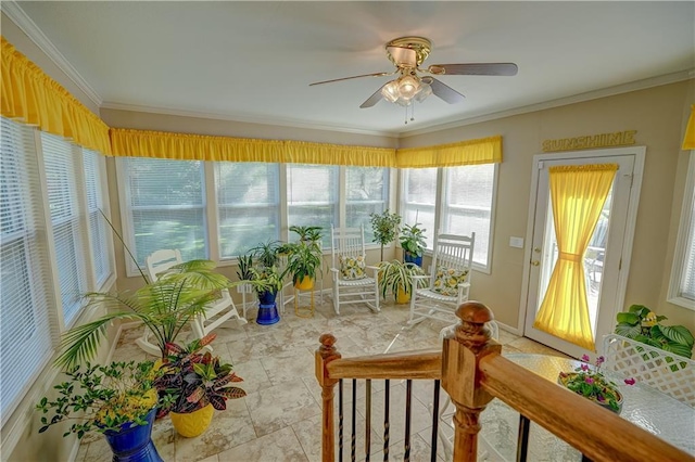sunroom / solarium with stone finish flooring and ornamental molding