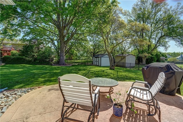 view of patio / terrace featuring an outbuilding, fence, and a shed