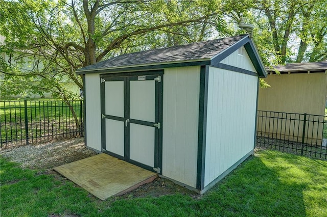 view of shed with a fenced backyard