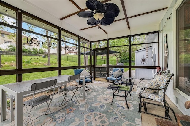 sunroom / solarium with a ceiling fan