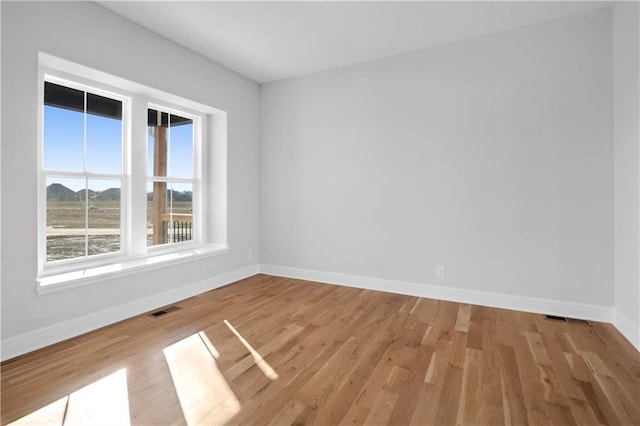 25256 W 149th Ter, Olathe, KS 66061 - empty room with baseboards, visible vents, and light wood-style floors