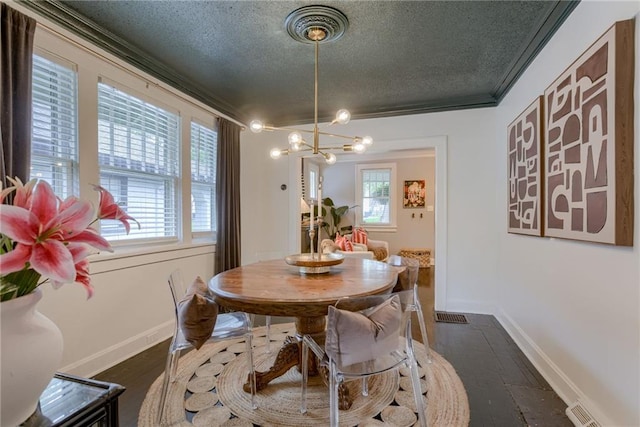 dining space featuring a textured ceiling, a chandelier, dark wood-style flooring, ornamental molding, and baseboards