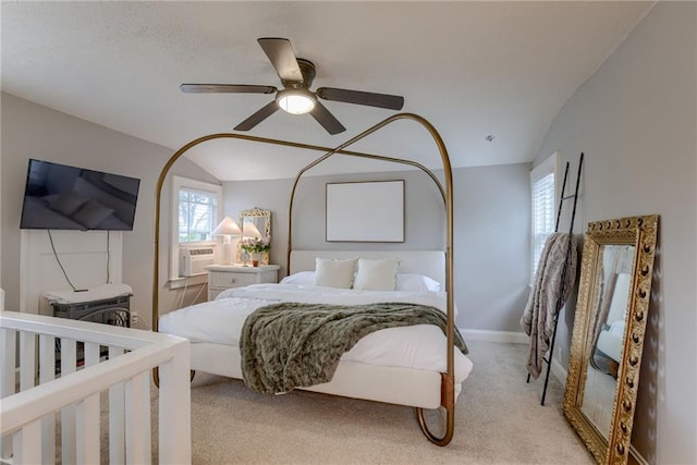 bedroom with light carpet, lofted ceiling, a ceiling fan, baseboards, and cooling unit