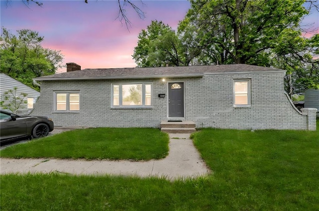1400 NE 67th Ter, Gladstone, MO 64118 - view of front of property with brick siding, a yard, and a chimney