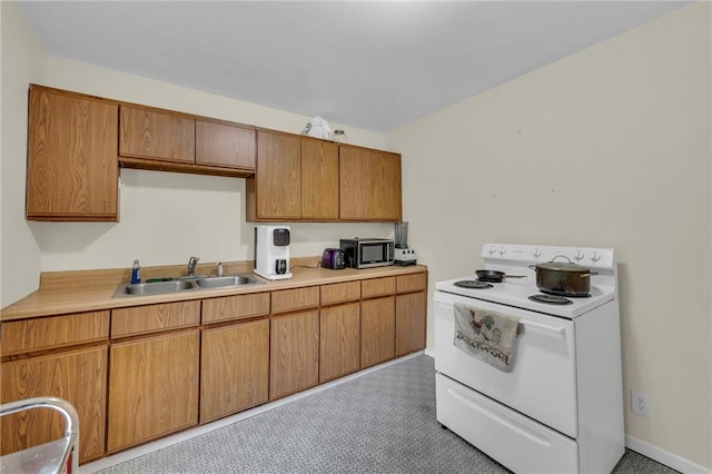 1400 NE 67th Ter, Gladstone, MO 64118 - kitchen with white electric range oven, stainless steel microwave, a sink, light countertops, and brown cabinets
