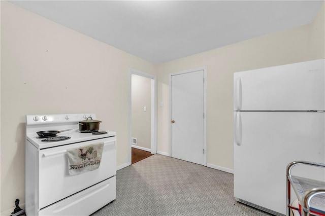 1400 NE 67th Ter, Gladstone, MO 64118 - kitchen featuring white appliances, baseboards, and light colored carpet
