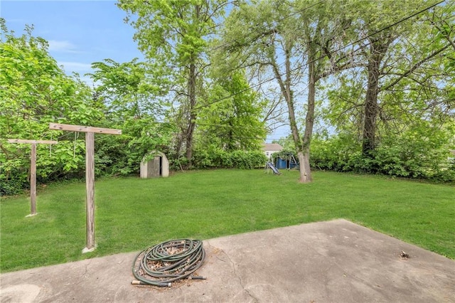 1400 NE 67th Ter, Gladstone, MO 64118 - view of green lawn featuring a storage shed, a patio area, and an outbuilding