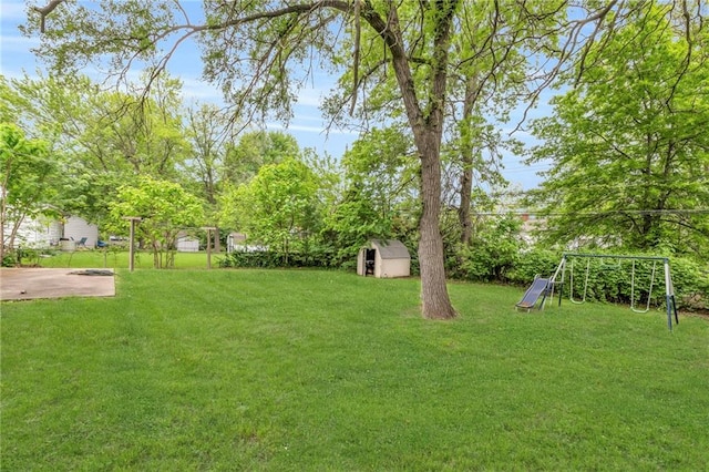 1400 NE 67th Ter, Gladstone, MO 64118 - view of green lawn featuring a shed, an outdoor structure, and a playground