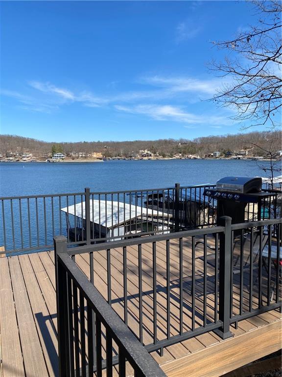 wooden deck featuring a water view