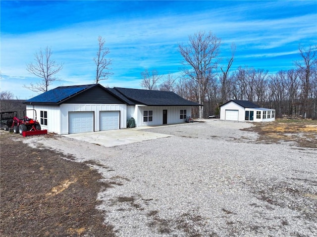 view of front facade featuring driveway, an attached garage, and board and batten siding
