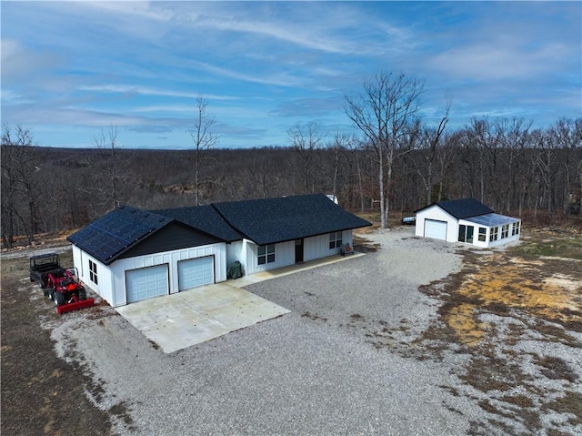 birds eye view of property with a view of trees