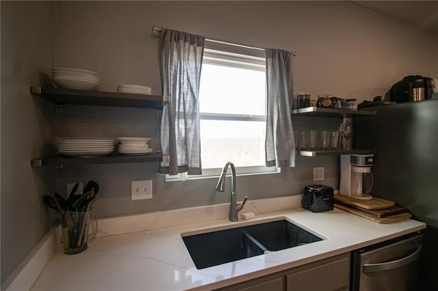 kitchen with open shelves, a sink, and dishwasher
