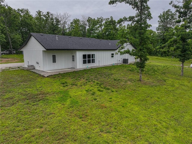 3813 Mt Horeb Rd, Camdenton, MO 65020 - rear view of property with board and batten siding, a yard, a patio, and a shingled roof