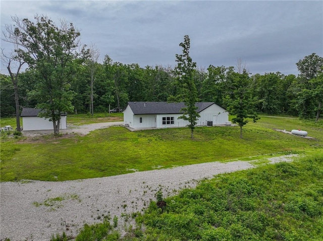 3813 Mt Horeb Rd, Camdenton, MO 65020 - view of green lawn with a view of trees, an outdoor structure, and driveway