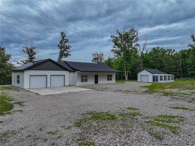 3813 Mt Horeb Rd, Camdenton, MO 65020 - view of front facade with board and batten siding, a garage, and an outbuilding