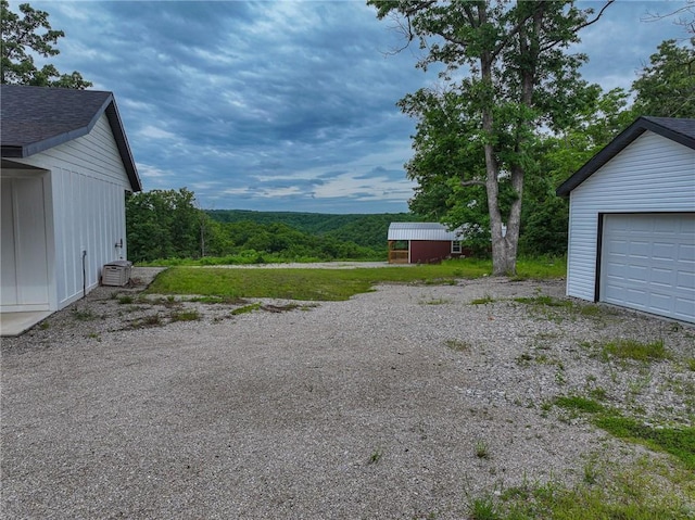 3813 Mt Horeb Rd, Camdenton, MO 65020 - view of yard featuring an outdoor structure, a garage, and driveway