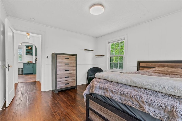 5801 E 56th St, Kansas City, MO 64129 - bedroom with hardwood / wood-style floors, crown molding, arched walkways, and baseboards