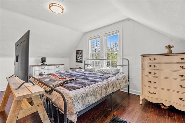 5801 E 56th St, Kansas City, MO 64129 - bedroom featuring lofted ceiling, dark wood-style flooring, and baseboards