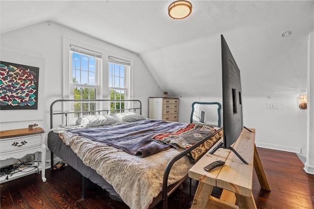 5801 E 56th St, Kansas City, MO 64129 - bedroom with vaulted ceiling, wood-type flooring, and baseboards