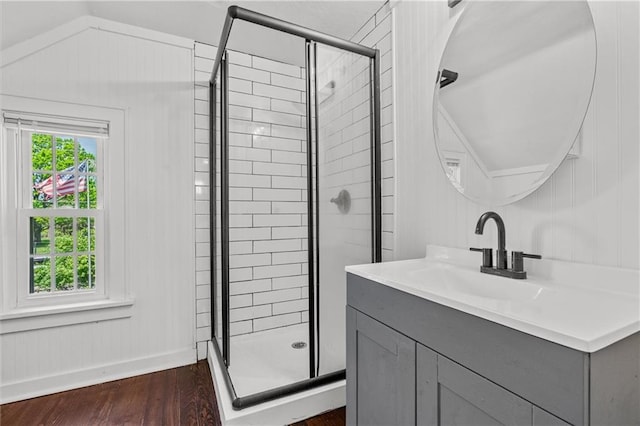5801 E 56th St, Kansas City, MO 64129 - full bathroom featuring a shower stall, wood finished floors, and vanity