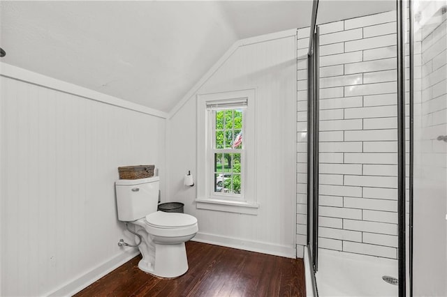 5801 E 56th St, Kansas City, MO 64129 - bathroom with wood-type flooring, a stall shower, lofted ceiling, toilet, and baseboards