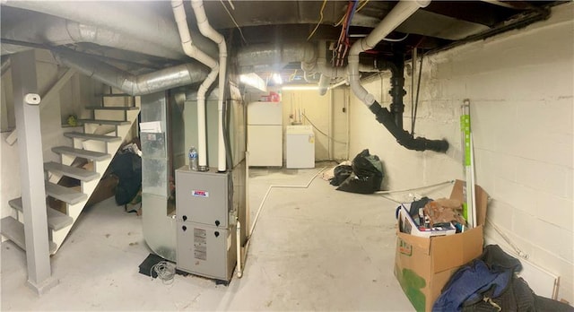 5801 E 56th St, Kansas City, MO 64129 - unfinished basement featuring washer / clothes dryer, heating unit, freestanding refrigerator, and stairway