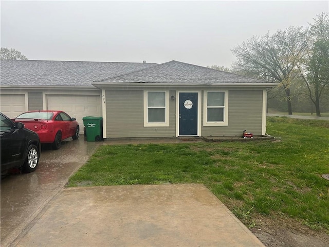 722 N Virginia St, Adrian, MO 64720 - view of front of home featuring an attached garage, a front yard, roof with shingles, and concrete driveway