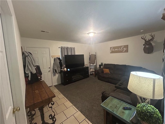 722 N Virginia St, Adrian, MO 64720 - carpeted living room featuring tile patterned flooring
