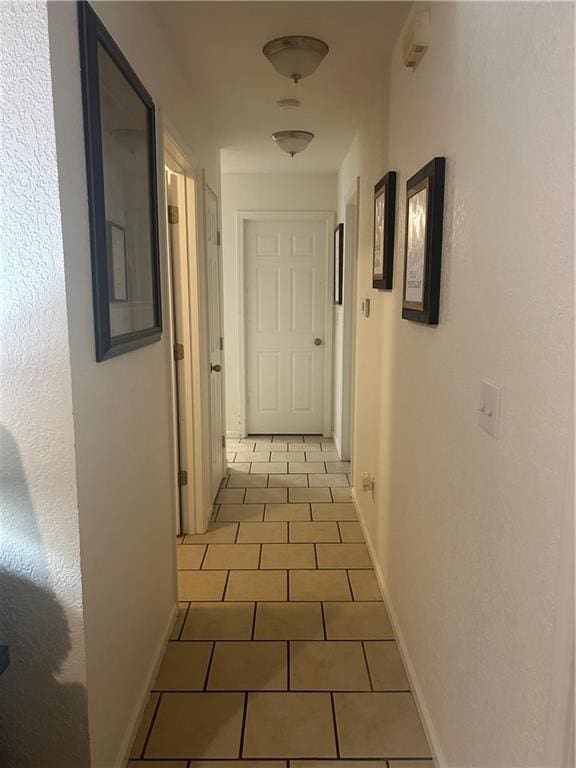 722 N Virginia St, Adrian, MO 64720 - hall featuring tile patterned flooring and baseboards