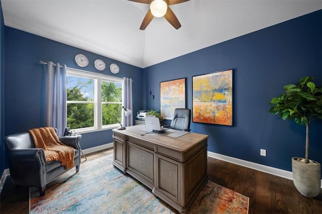 office area featuring ceiling fan, baseboards, vaulted ceiling, and wood finished floors