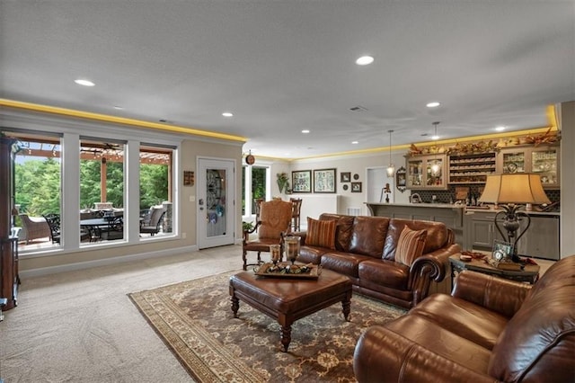 carpeted living room featuring ornamental molding and recessed lighting